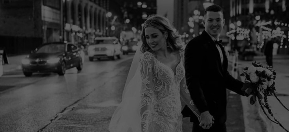 Сouple wearing a white gown and a black suit